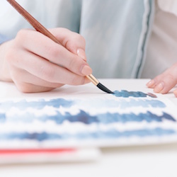 A painter applies their best creativity practices in watercolors.